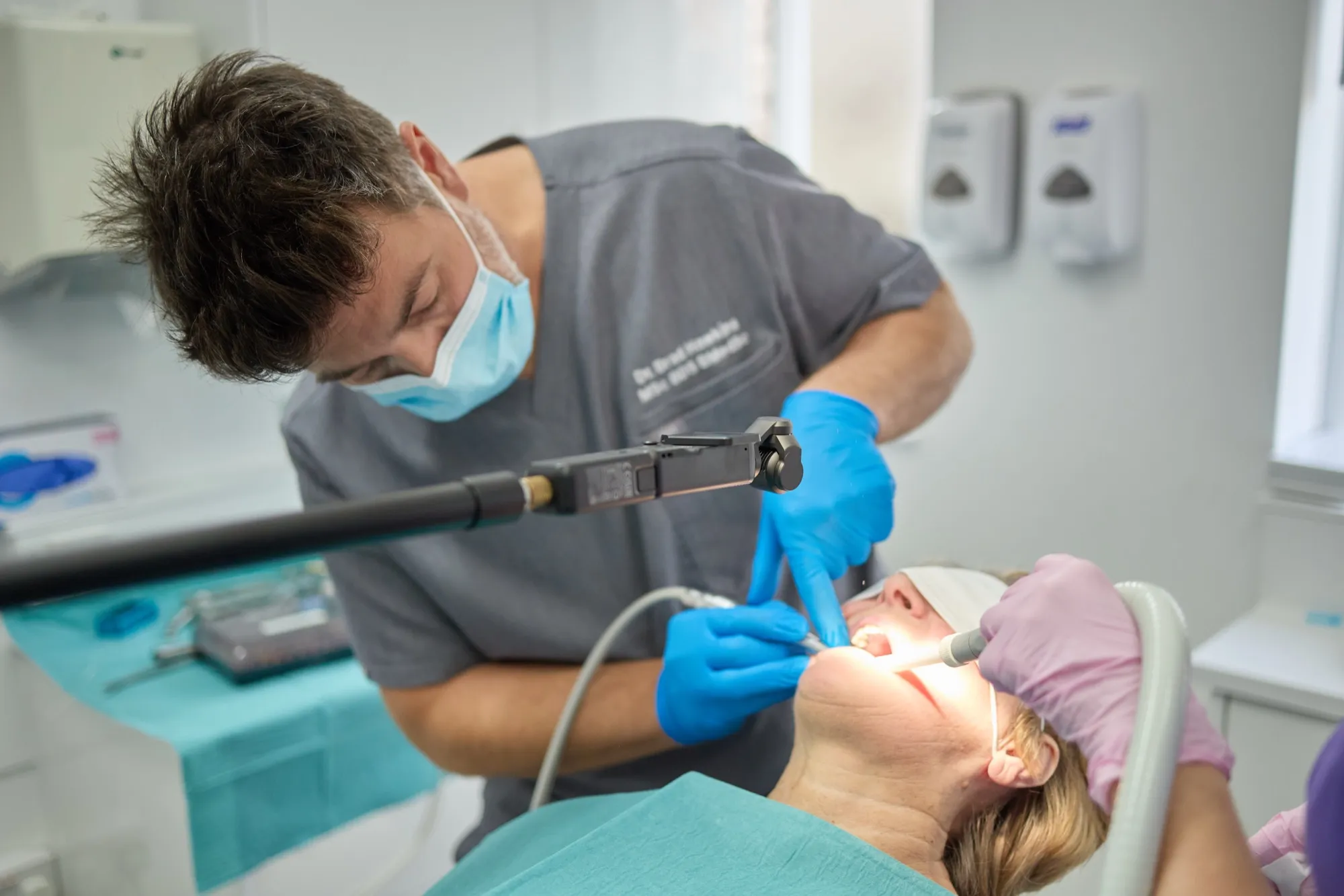 Dr Brad Hawkins treating a patient under the surgical light