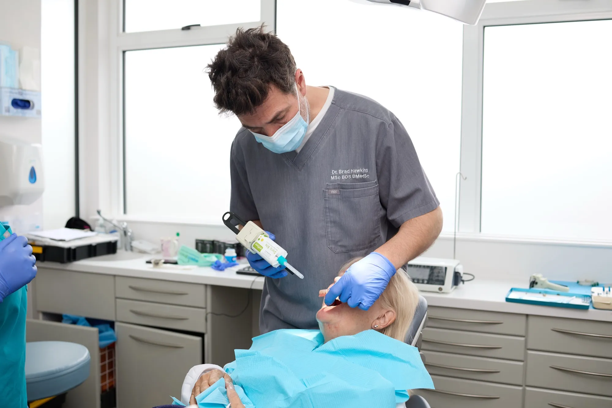A treatment room mid-appointment, a patient being treated in the chair