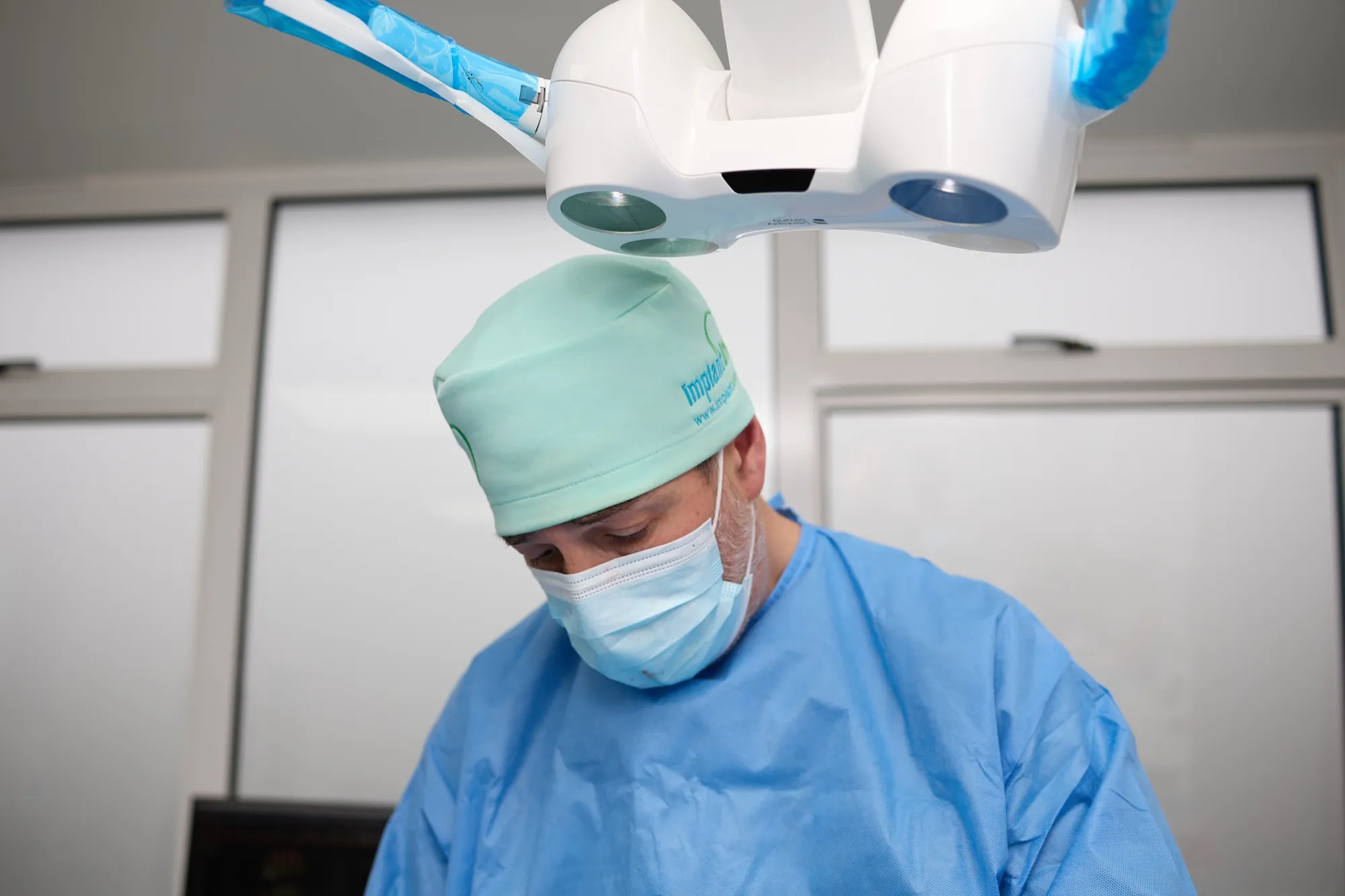 Dr Brad Hawkins working under the theatre light during implant surgery