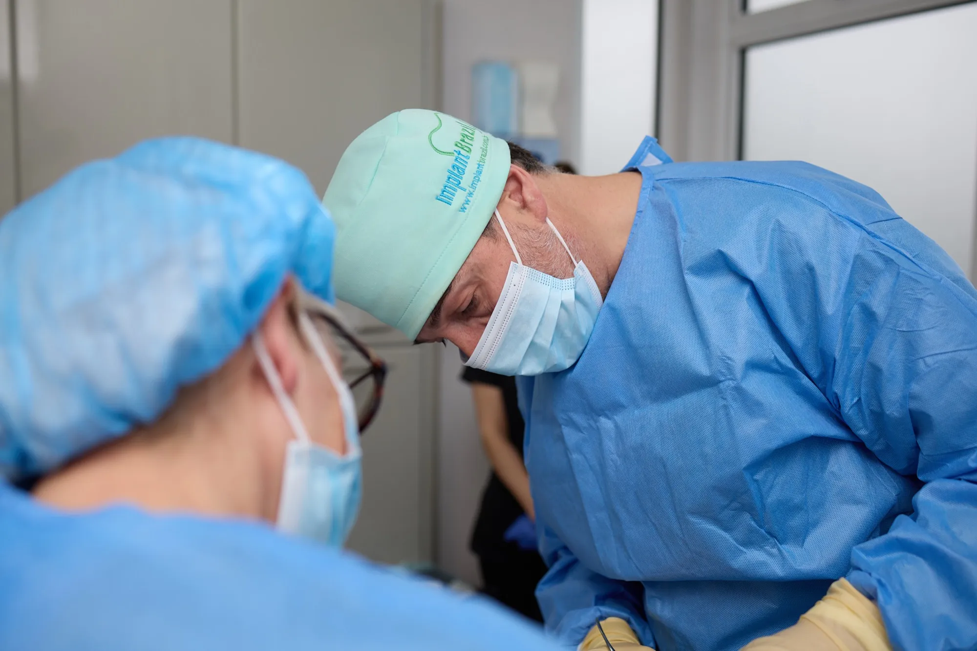 Dr Brad Hawkins and an assistant gowned and working together during an implant case