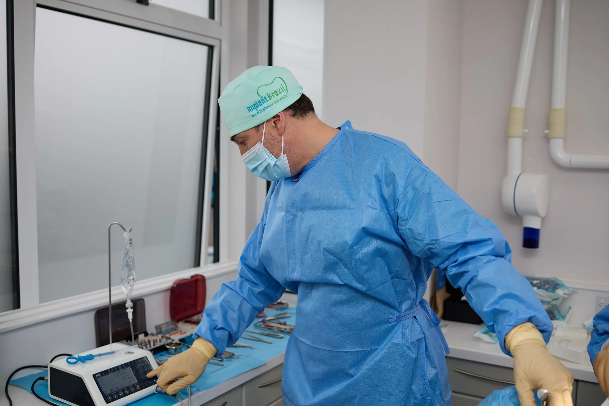 Dr Brad Hawkins gowned and preparing surgical equipment before an implant case