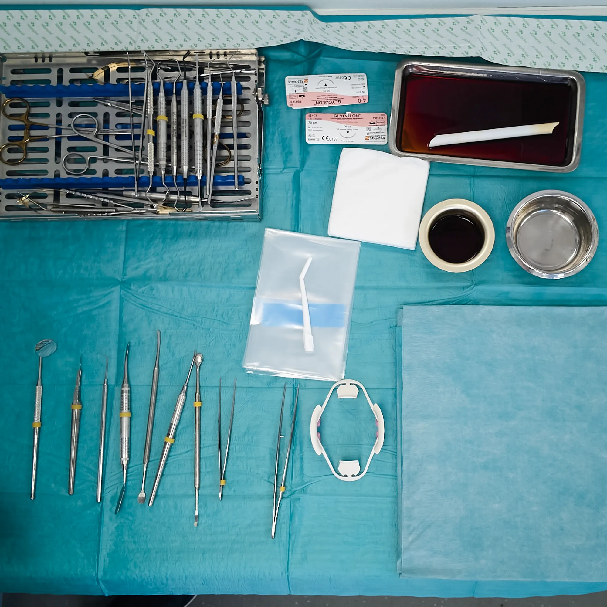A surgical tray laid out for dental implant placement, instruments arranged in order on a sterile drape