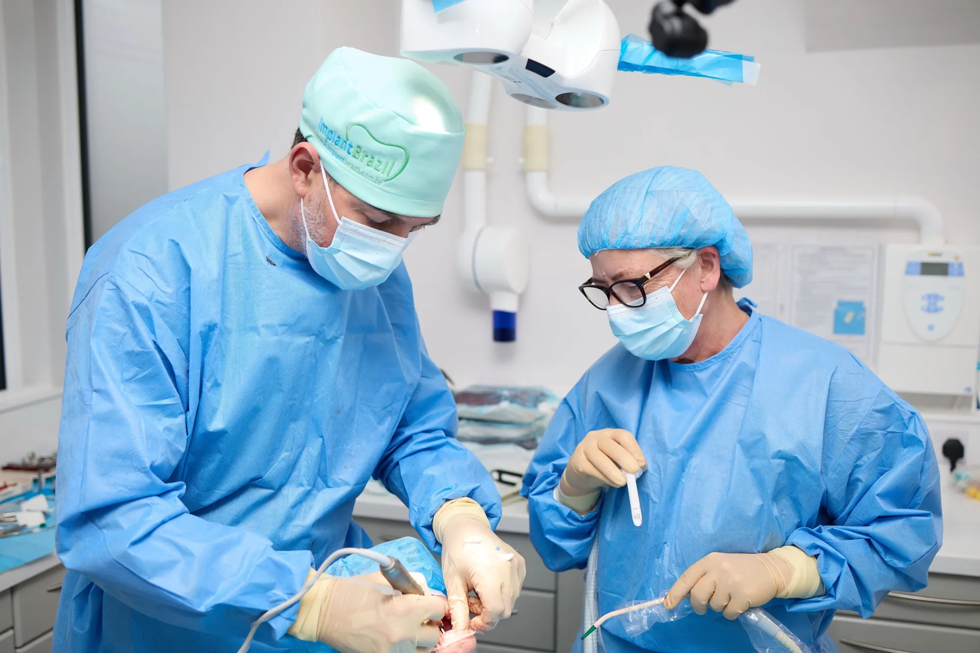 Dr Brad Hawkins and a surgical assistant working together during an implant case